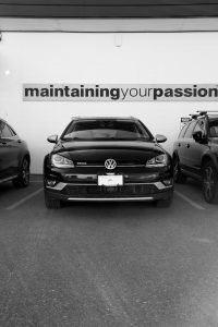 Front view of Volkswagen SUV under "maintaing your passion" sign at Motor Werke - VW service Kelowna.